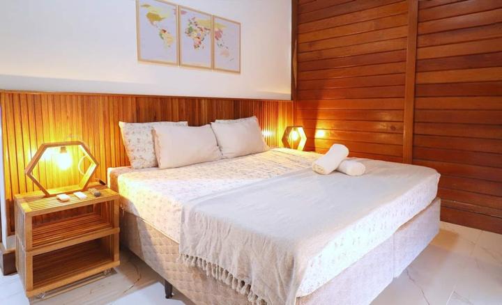 King bed under warm lamplight